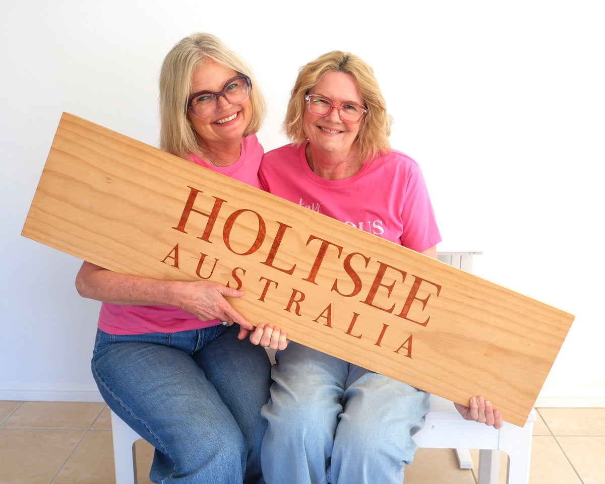 Lynda and Susie Holt holding the HOLTSEE AUSTRALIA sign