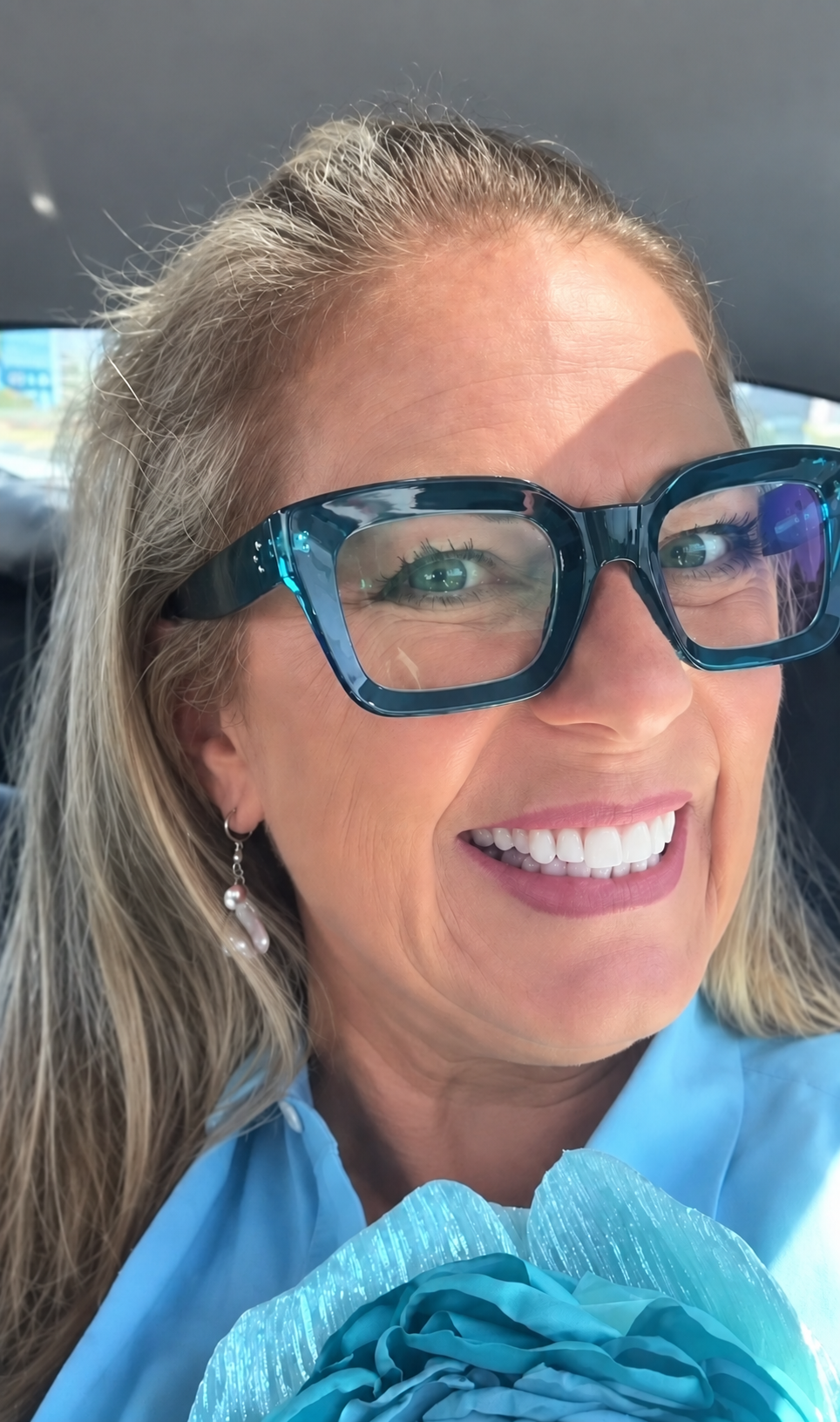 Smiling woman wearing blue Holtsee frames